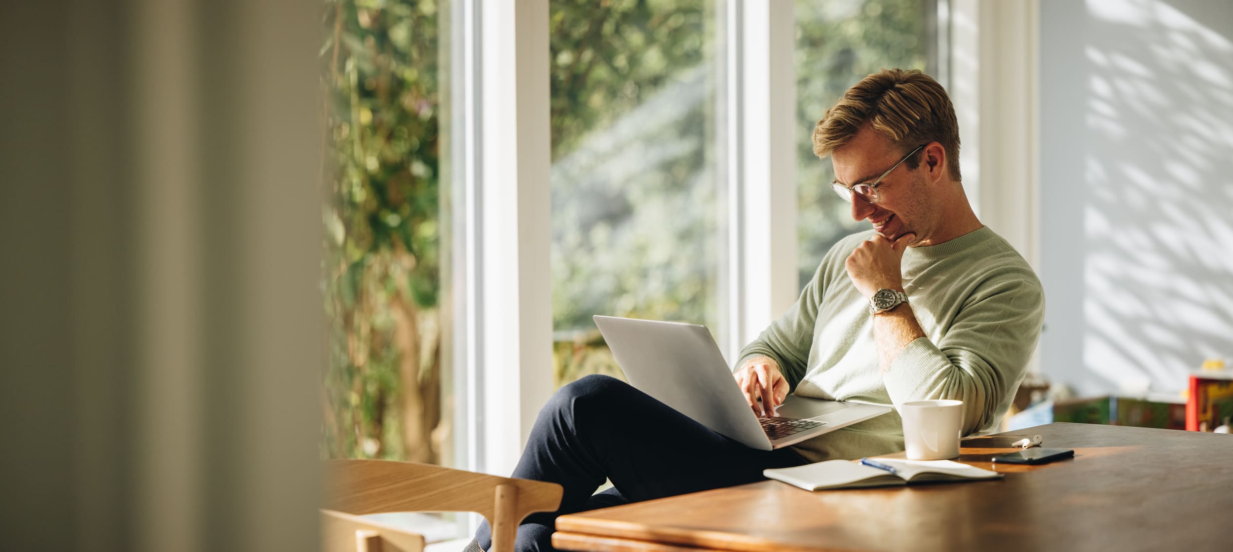 A man smiles while using a computer